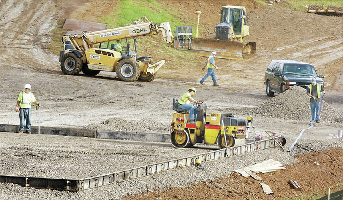 Construction workers are shown laying the groundwork of a $14 million project near the east levee at the mouth of Wood River Creek in East Alton near the power plant on Illinois Route 143 last August. Local officials toured the construction Monday.