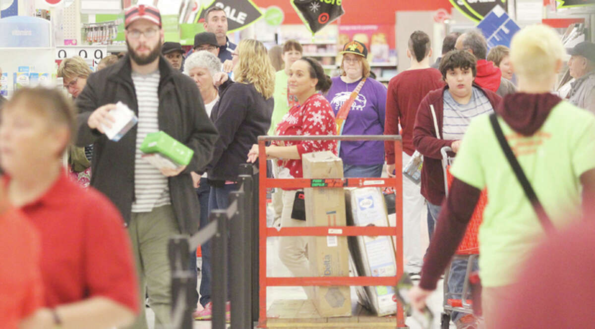 Crowds line up to check out at the Alton Target store Thursday night after completing their traditional Thanksgiving meals as stores open earlier for Black Friday sales.