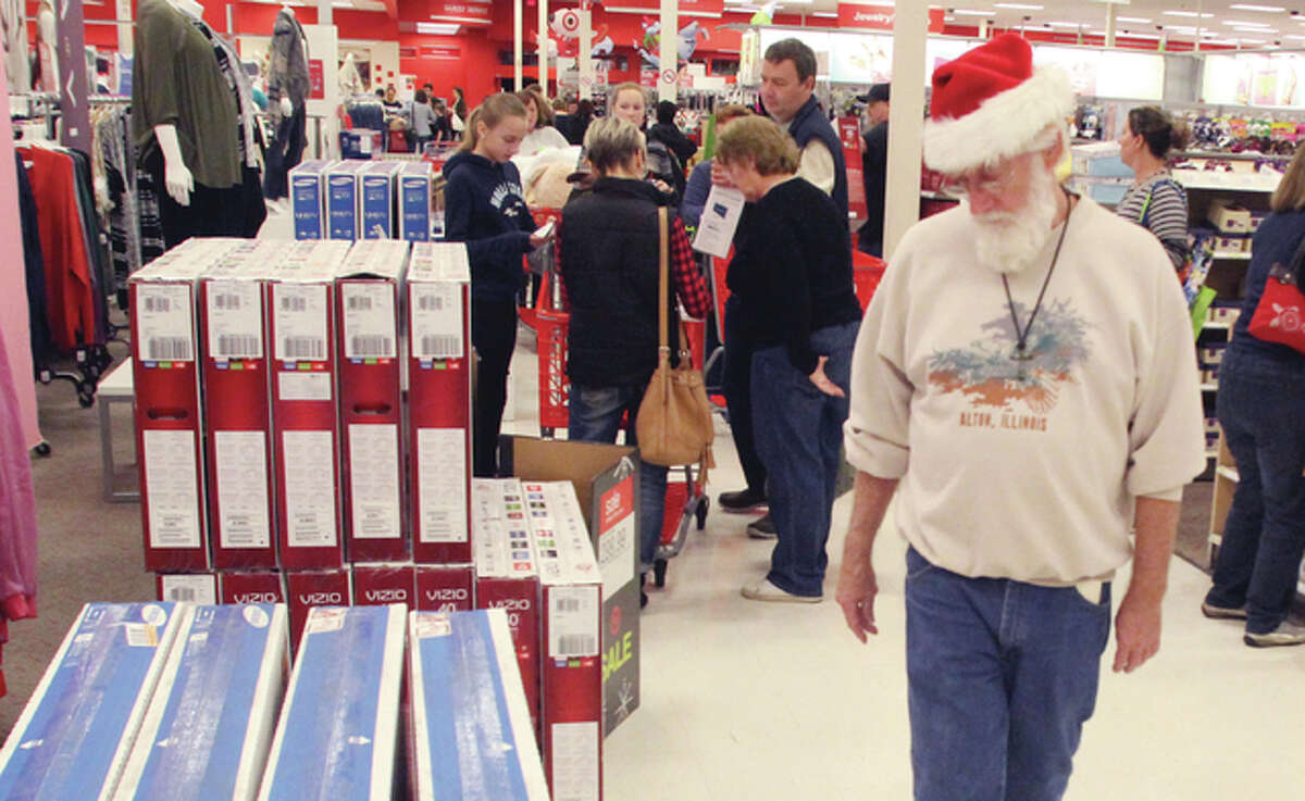 Wearing a Santa hat, Jerry Webb, of Alton, wanders through Target Thursday evening. Large crowds were wrapped around the store when it opened at 6 p.m. Thursday.
