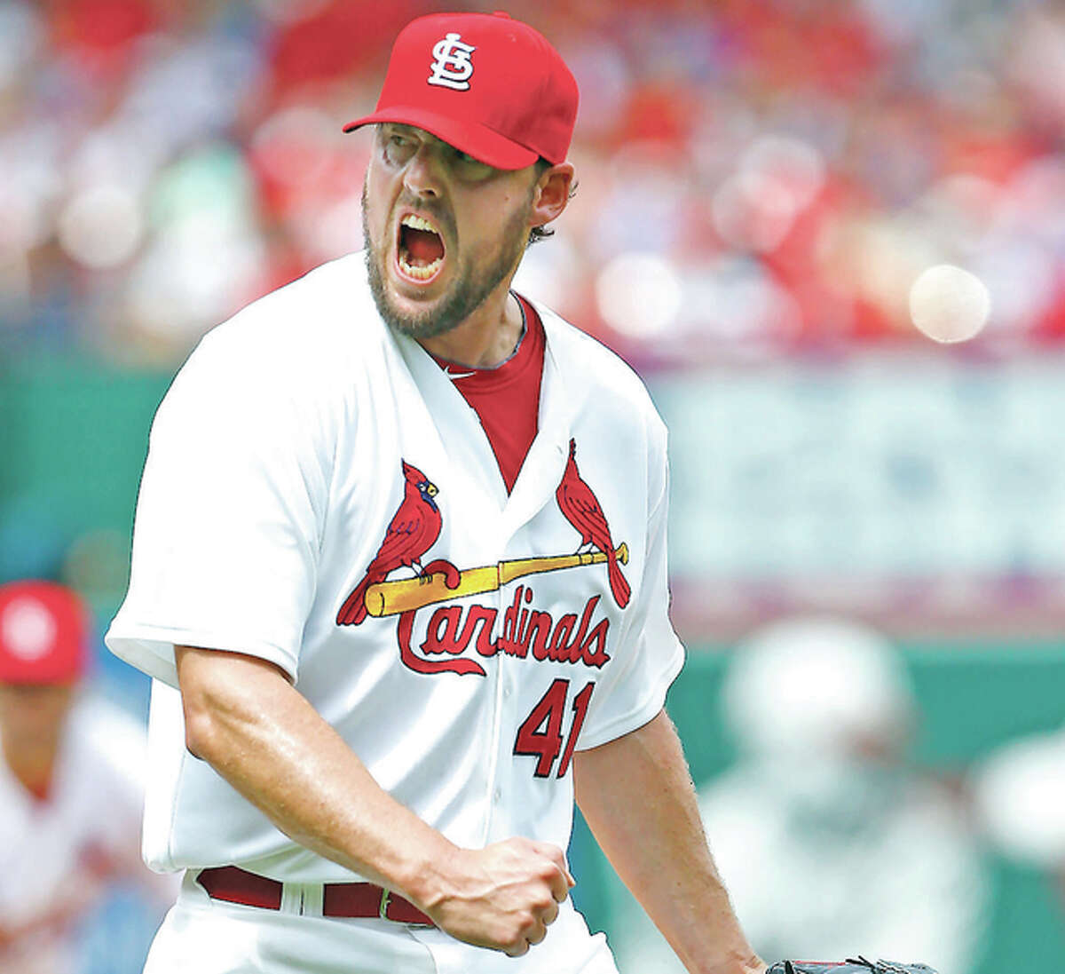 Former Cardinals starting pitcher John Lackey reacts after striking out Chicago Cubs’ Anthony Rizzo in a game last season at Busch Stadium. Lackey signed a free-agent contract with the Cubs Friday.