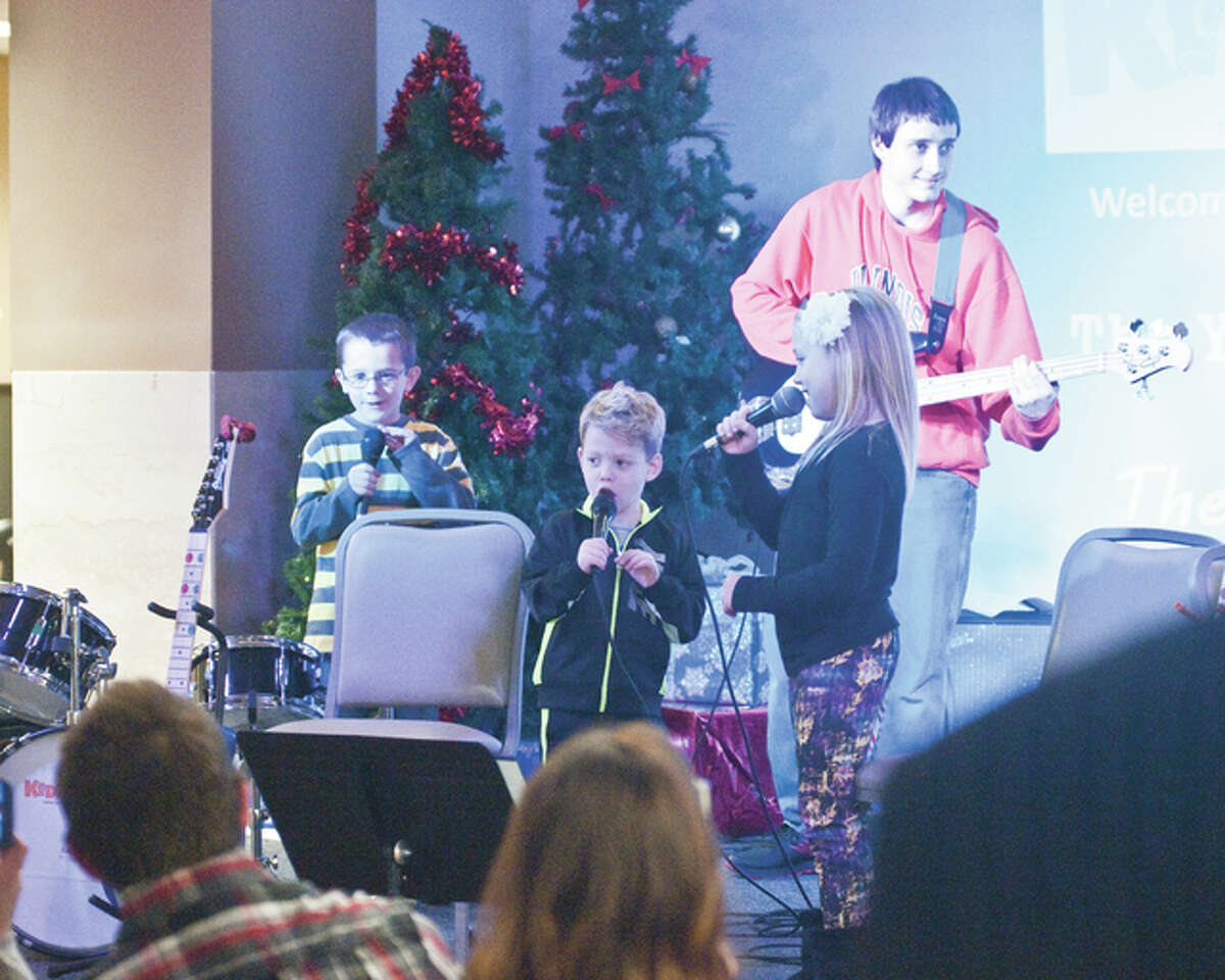 Ethan Eggebrecht, Jonah Cohill and Madeline Cohill, part of the “Yellow Rock’n Trolls,” showcased their singing talents on Sunday at the Riverbender.com Community Center during the Kidzrock concert.