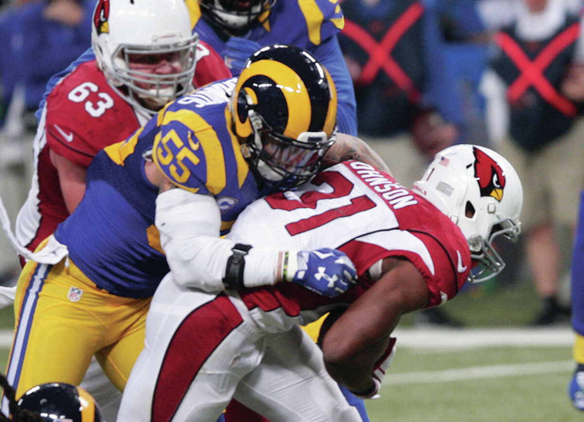 Rams middle linebacker James Laurinaitis (middle) pulls down Cardinals running back David Johnson during Arizona’s victory on Sunday afternoon at the Edward Jones Dome in St.Louis.