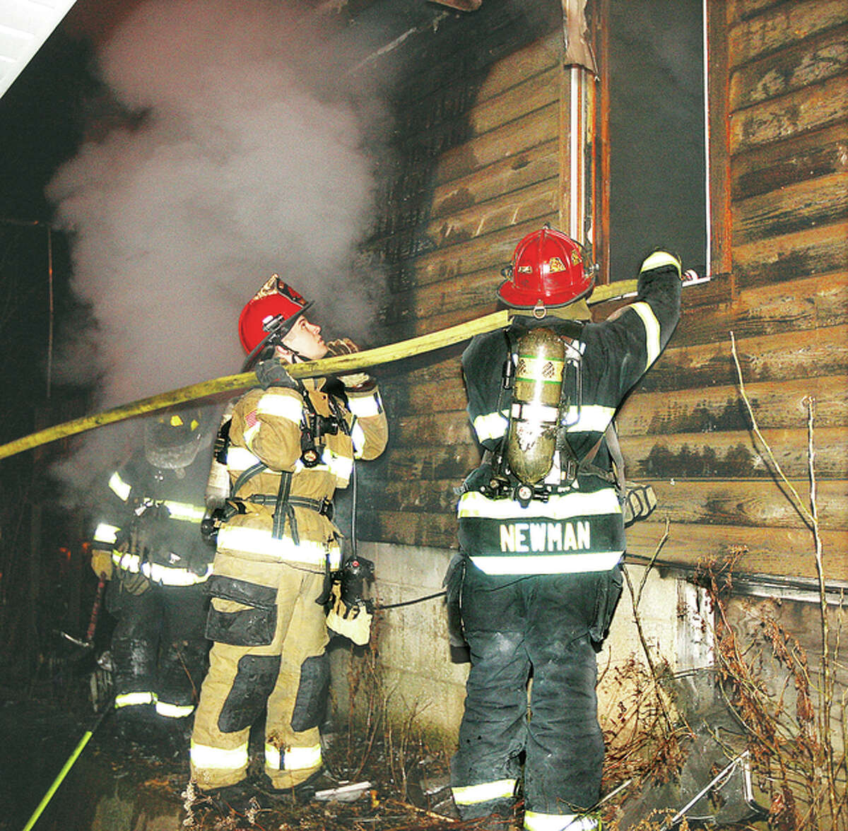Firefighters direct a hose line through a window of the vacant house as they bring the flames under control. Owners of the structure told firefighters the interior was in rough shape so firefighters didn’t enter the structure until most of the fire had been knocked down.