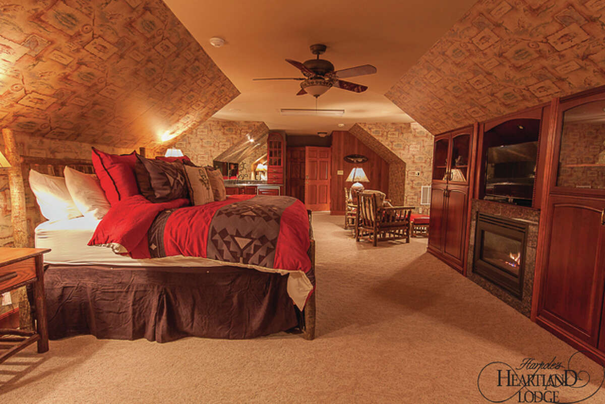 One of Harpole’s Sunset Valley Lodge’s bedroom suites with a fireplace.