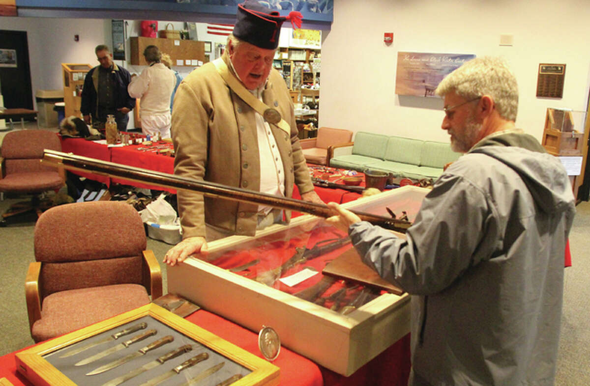 Presenter Jim Duncan and Steve Bollini, of Godfrey, talk about rifles carried by members of the Lewis and Clark Expedition Sunday at the Arrival at Camp River Dubois celebration at the Lewis and Clark State Historic Site Interpretive Center. The Lewis and Clark Expedition — officially known as the Corps of Discovery — arrived at their winter camp Dec. 12, 1803.