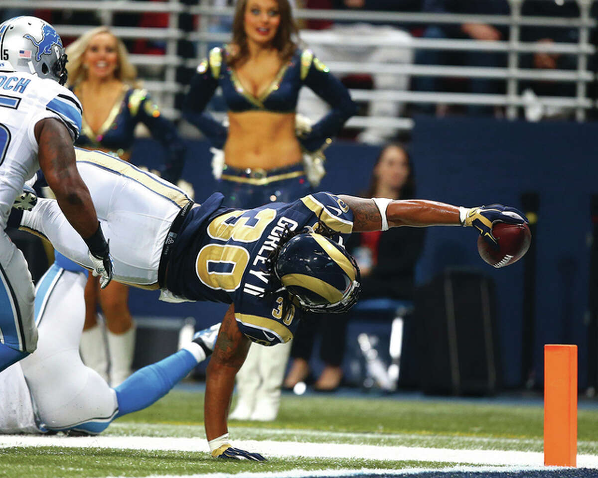Rams running back Todd Gurley (30) extends the football for a touchdown against the Detroit Lions on Sunday at the Edward Jones Dome in St. Louis. The Rams won 21-14.