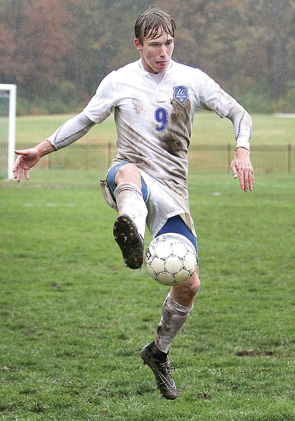 Blake Cearns settles the ball on a muddy field in postseason action against rival Southwestern Illinois College.