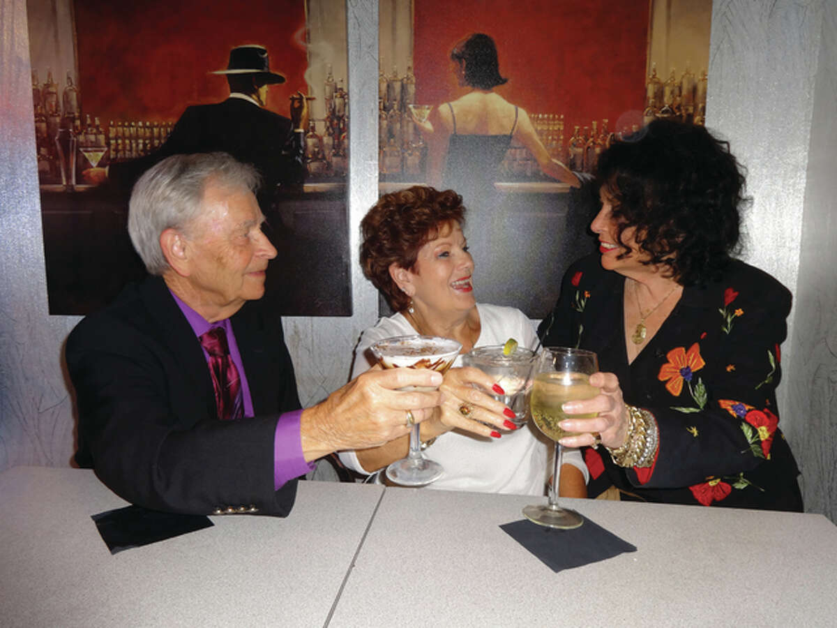 Bob and Thelma Hunter, of Bethalto, celebrate a toast with Chez Marilyn restaurant and cocktail lounge owner Marilyn Carroll.