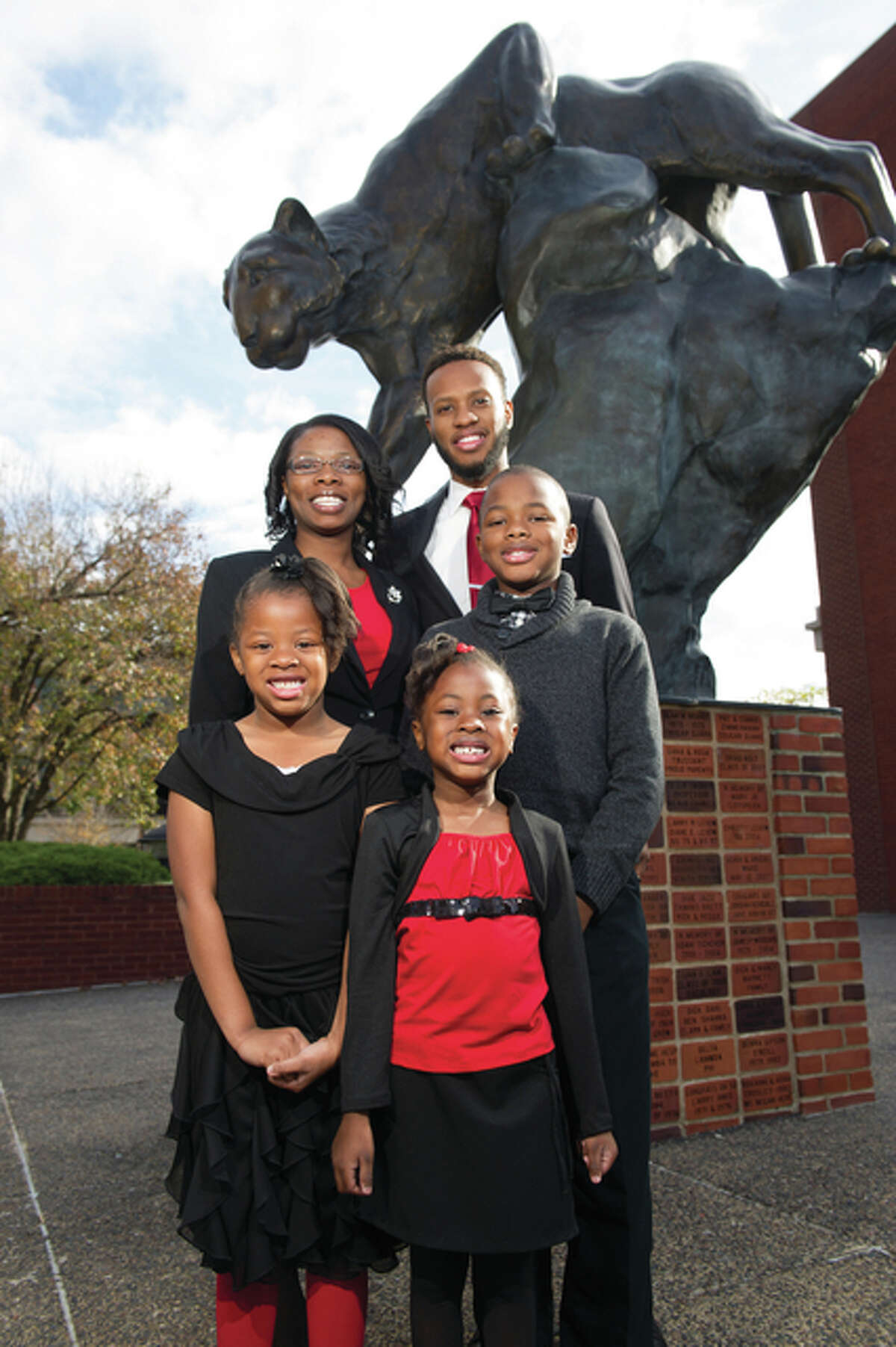 Brandi Jackson shares in the excitement of her graduation with her husband and three children.