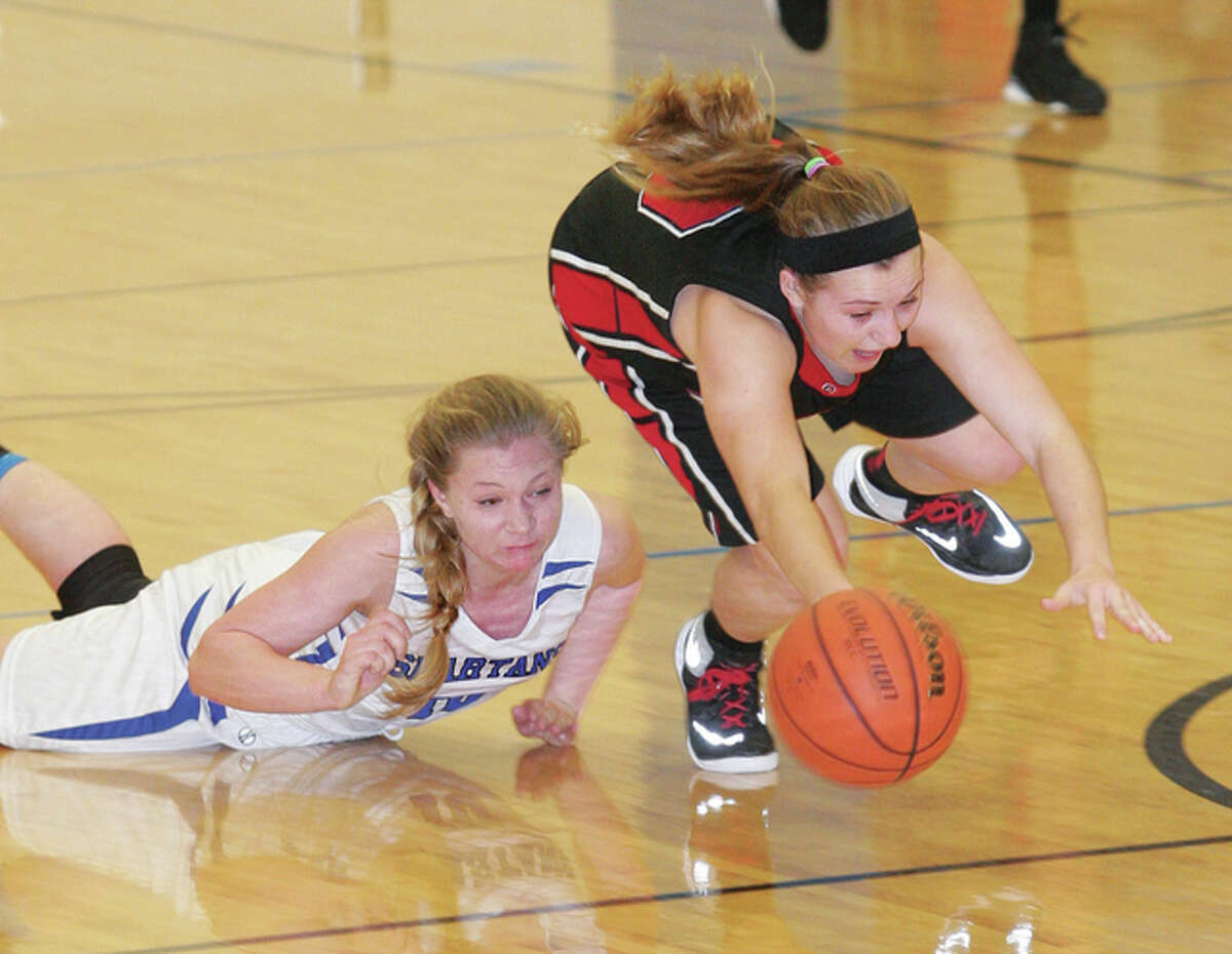 Calhoun’s Sydney White (right) and North Greene’s Madi Evans go to the floor in pursuit of a loose ball during a Warriors victory Monday night in White Hall. White is one of five returning starters back from last season’s Class 1A state runner-up team for Calhoun, which is off to an 9-1 start.