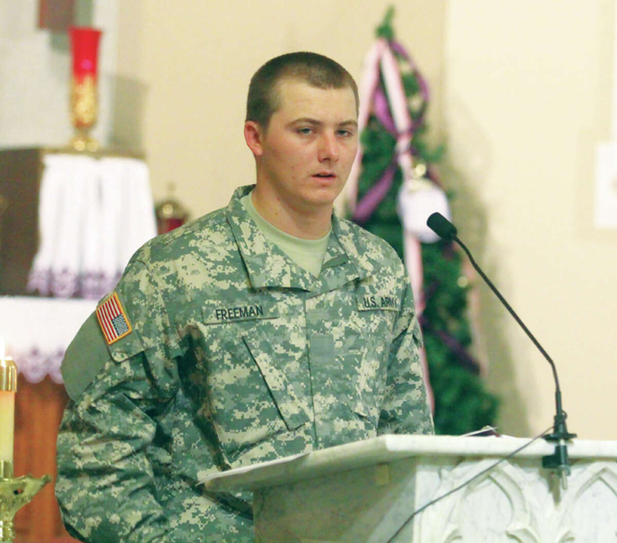 Pvt. Thomas Freeman, who is undergoing basic training at Fort Jackson, South Carolina, speaks briefly during a Mass honoring those serving in the military. The service is held monthly at SS Peter and Paul Church.