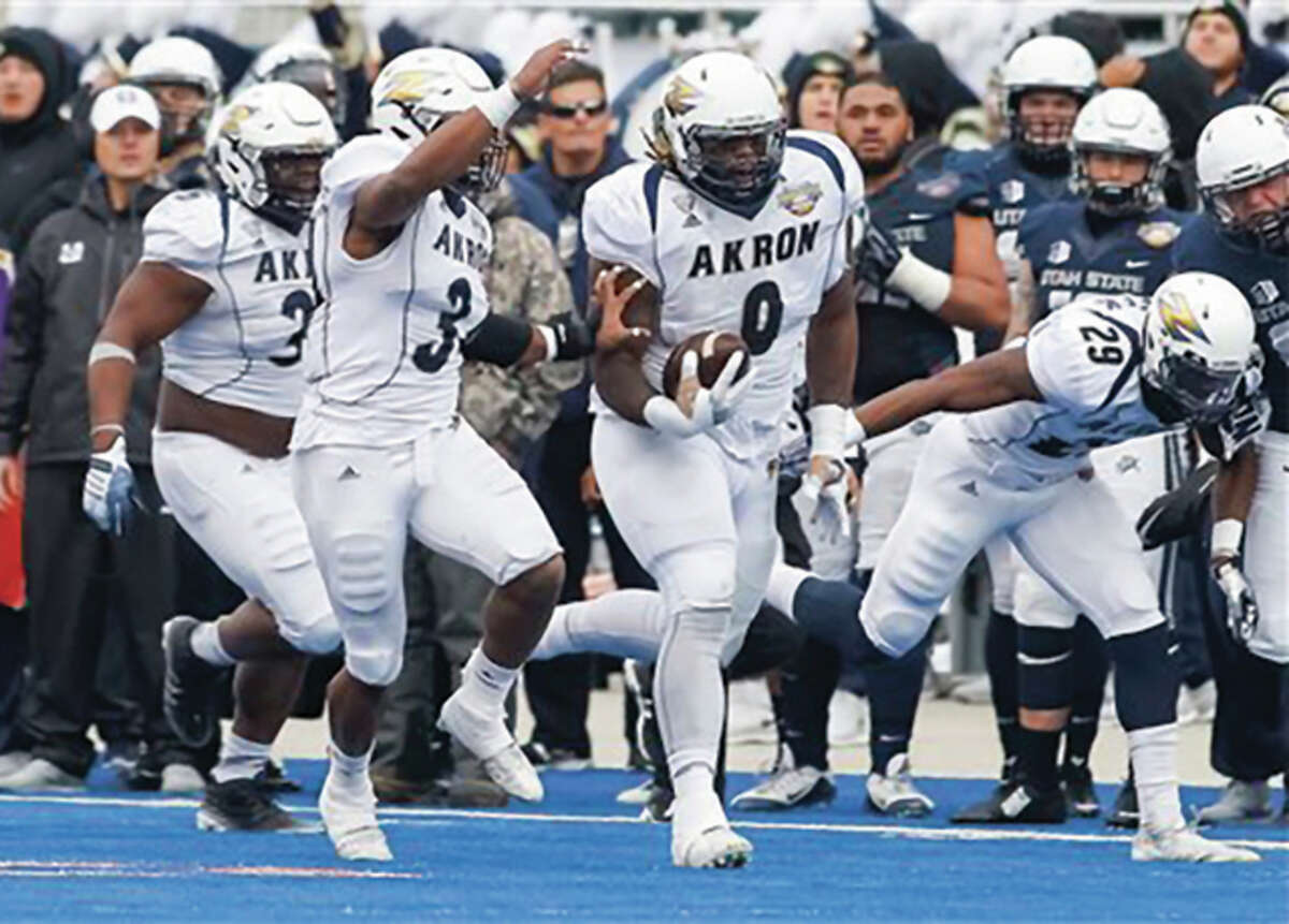 Akron Zips defensive tackle Rodney Coe (middle, right) returns a recovered fumble 56 yards to set up a 29-yard field goal on the final play of the first half in the Zips’ 23-21 victory over Utah State in the Famous Idaho Potato Bowl on Tuesday in Boise, Idaho. Coe, a former Telegraph Player of the Year with the Edwardsville Tigers, ended his college career with the bowl victory. Coe was the top-ranked running back prospect in Illinois in 2010 as a 6-foot-3, 238-pound senior at Edwardsville. Coe committed to Iowa out of high school, but spent two seasons at Iowa Western Community College before playing his junior season at Iowa State. After taking a redshirt season as a transfer in 2014, the 305-pound Coe helped Akron to an 8-5 record and its first FBS bowl win as a senior.