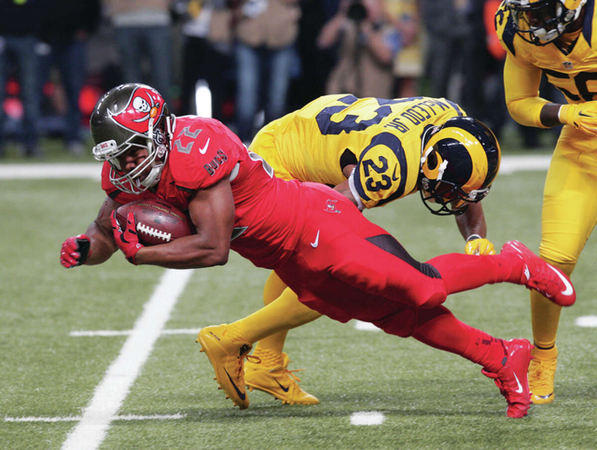 Tampa Bay running back Doug Martin is stopped by Rams safety Rodney McLeod during the Rams’ victory Dec. 17 Bay at the Edward Jones Dome in St. Louis. The Rams are on the road Sunday to play the Seahawks in Seattle.