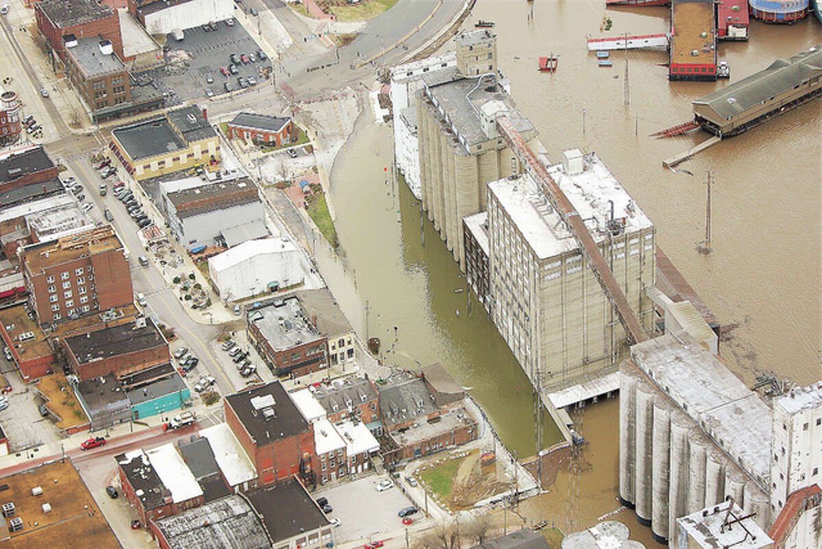 Downtown Alton, including the Ardent Mills and Argosy Casino entrances, right, were under water as the flood crested Thursday at the fourth highest level in recorded history. Many businesses along Third Street downtown, left, suffered extensive basement flooding due to the rising floodwaters.