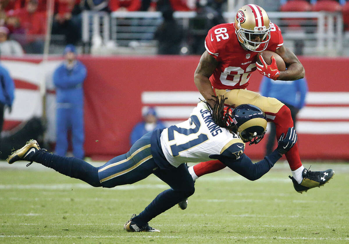 49ers wide receiver Torrey Smith (top) tries to jump over Rams cornerback Janoris Jenkins (21) during overtime of the Niners’ win Sunday in Santa Clara, Calif.