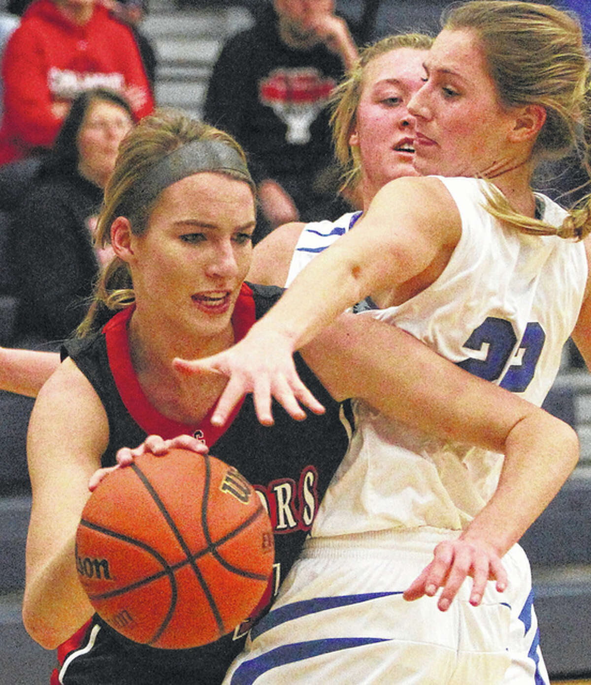 Calhoun’s Grace Baalman (left), shown pushing past North Greene’s Sydney McClenning during a Warriors win Dec. 14 in White Hall, scored 19 points Monday to lead the Warriors past Brussels in Hardin.