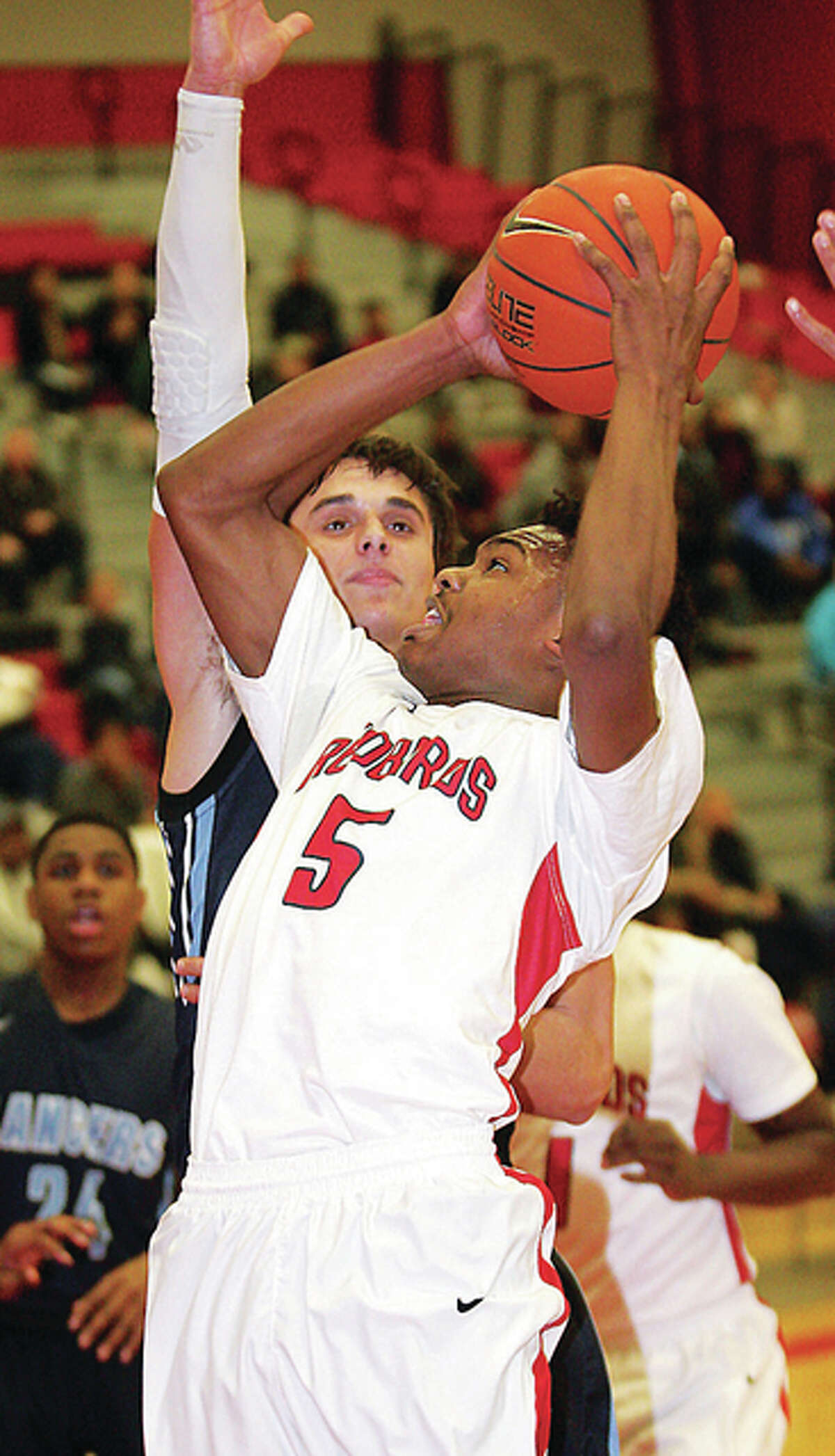 Alton’s Jordan Golley goes up against Belleville East’s Andrew Millas Tuesday in Alton.