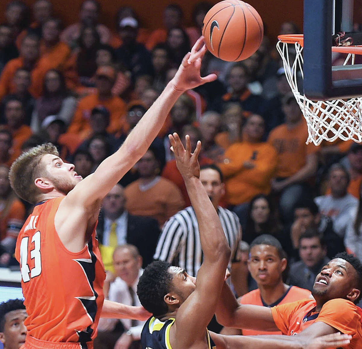 Illinois forward Michael Finke goes up and reaches for the ball in last week’s home loss to Michigan at State Farm Center.