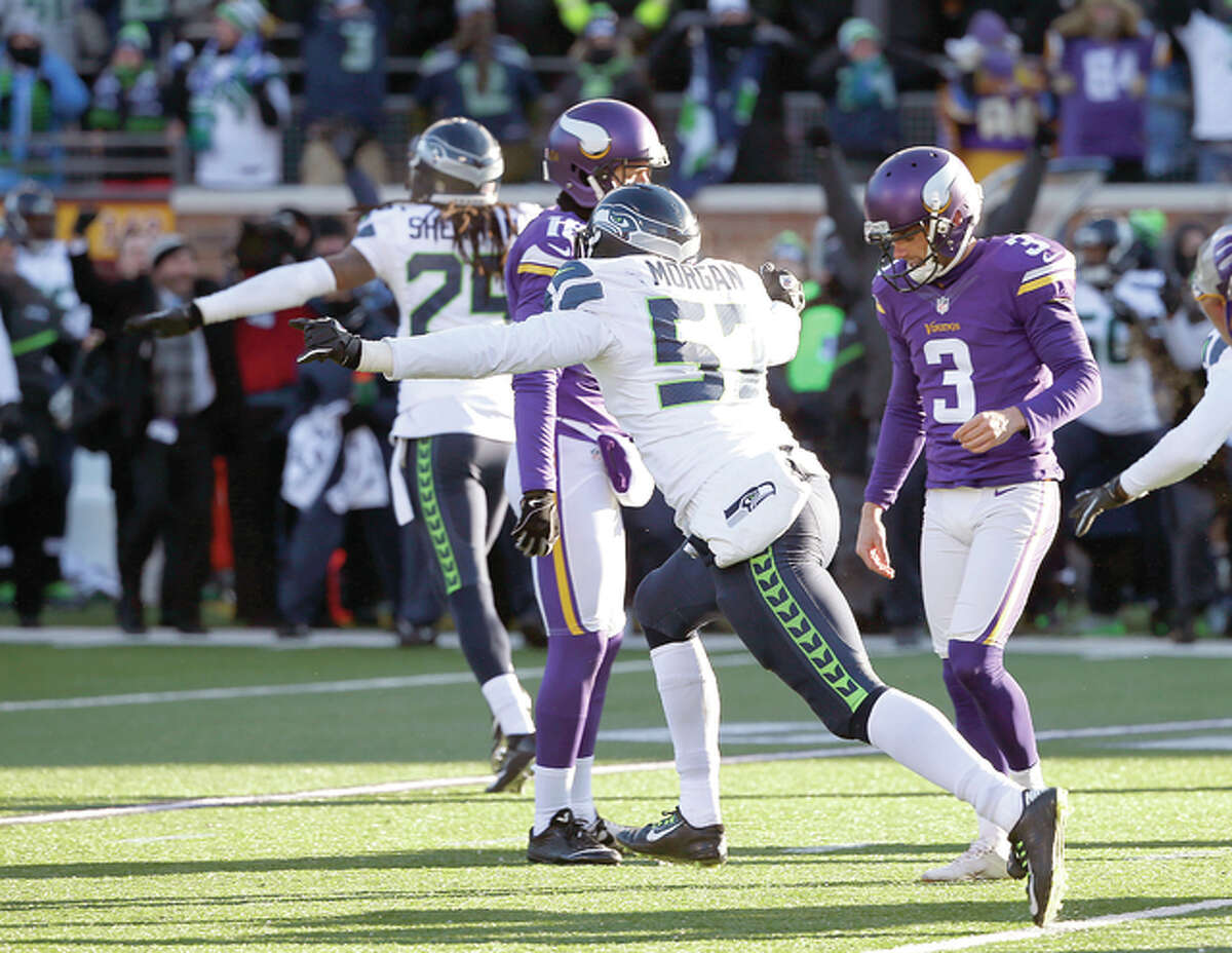 Minnesota Vikings kicker Blair Walsh (3) reacts and Seahawks players celebrate after Walshed missed a 27-yard field goal with 22 seconds left in Sunday’s wild-card playoff game in Minneapolis. The Seahawks won 10-9.