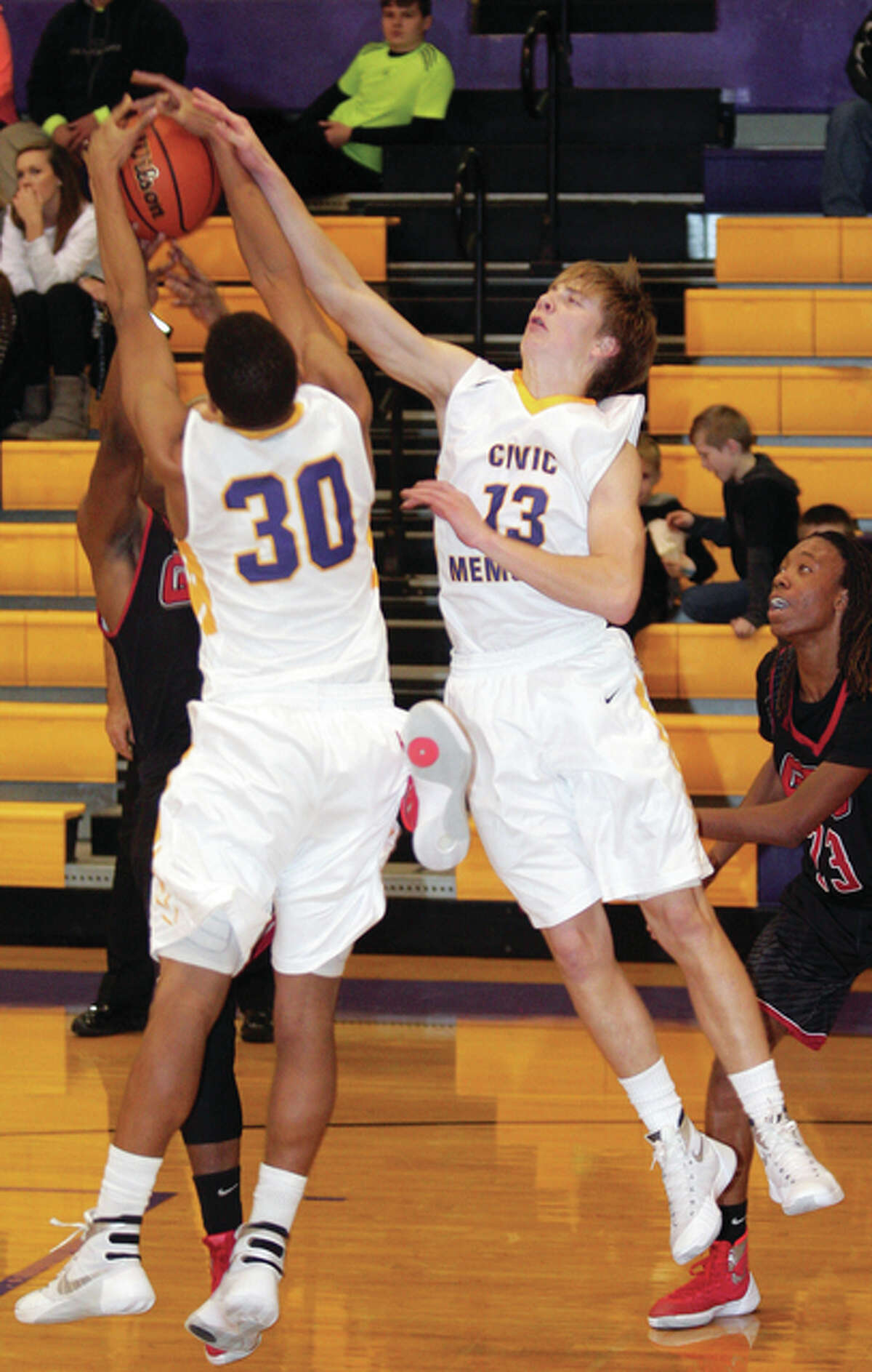 CM’s JaAQuan Adams, center, and David Lane, right, fight for a rebound with Granite City’s Ronn Allen, back, Tuesday.