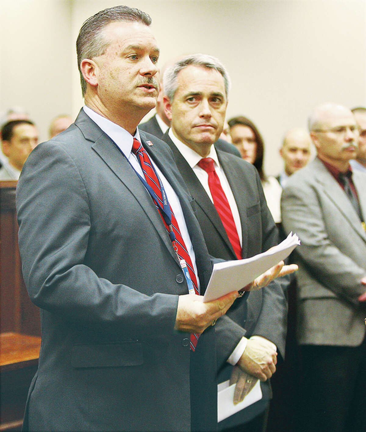 Maj. Jeff Connor, deputy commander of the Major Case Case Squad of St. Louis in Illinois, left, talks to the press Thursday at the Alton Law Enforcement Center about the arrest of an 18-year-old male in connection with the homicide of 11-year-old Romell Jones. Madison county State’s Attorney Tom Gibbons, right, listens before addressing the press. Jones was not the intended target of the shooting.