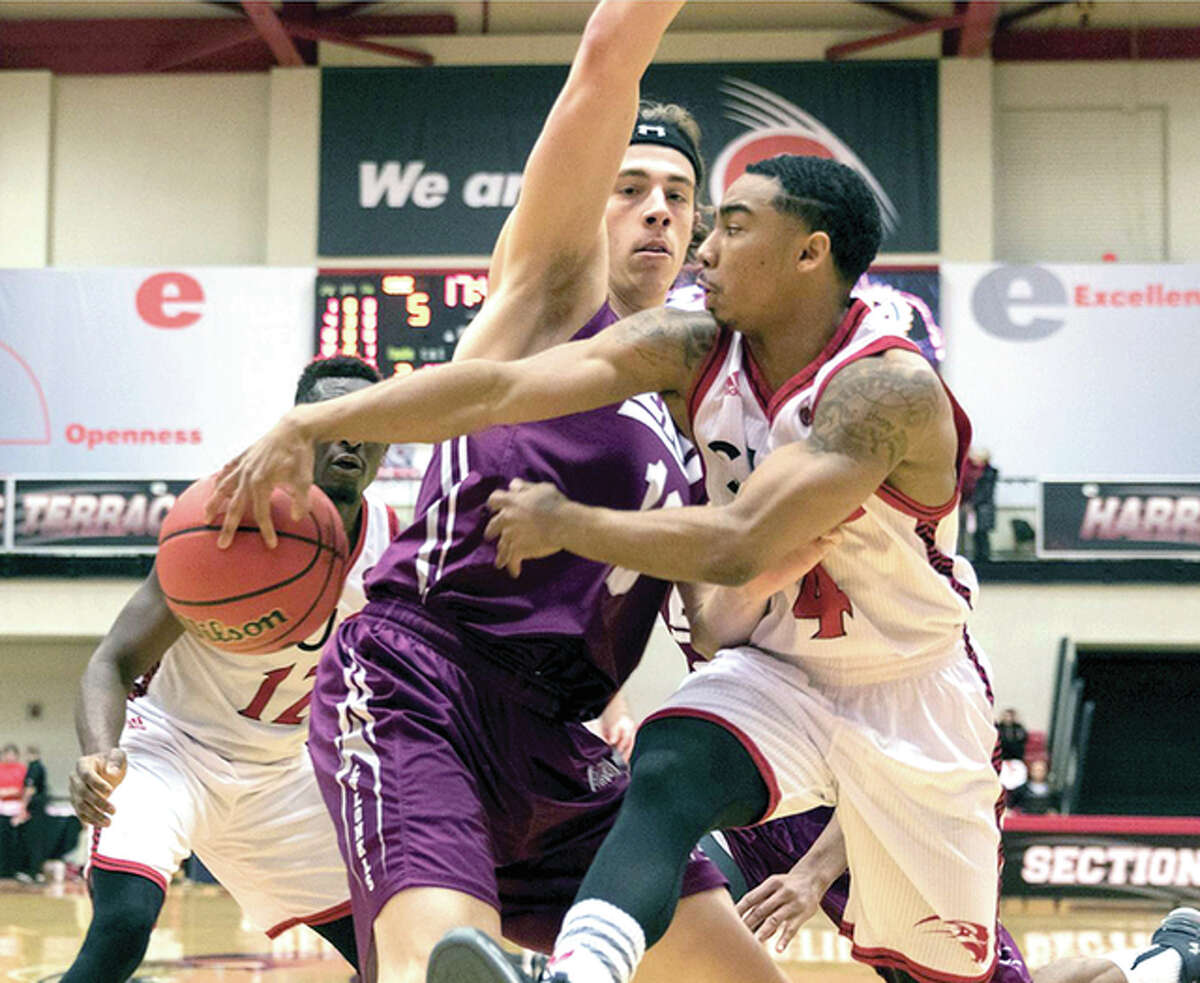 C.J. Harris of SIUE, right, tries to pass the ball around an Eastern Kentucky defender Saturday in OVC action at the Vadalabene Center.