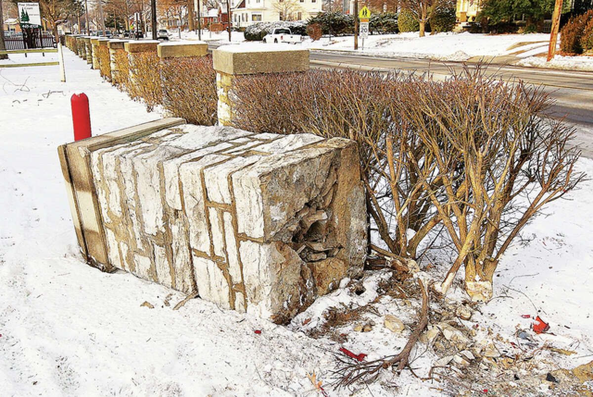 The impact from the second chase toppled one of many limestone pillars in front of the Pine Meadow Court Apartments, which, inter-spaced with bushes, form a fence in front of the complex. Just two hours earlier, the neighborhood where the crash occurred would have been full of children leaving nearby East Elementary School.