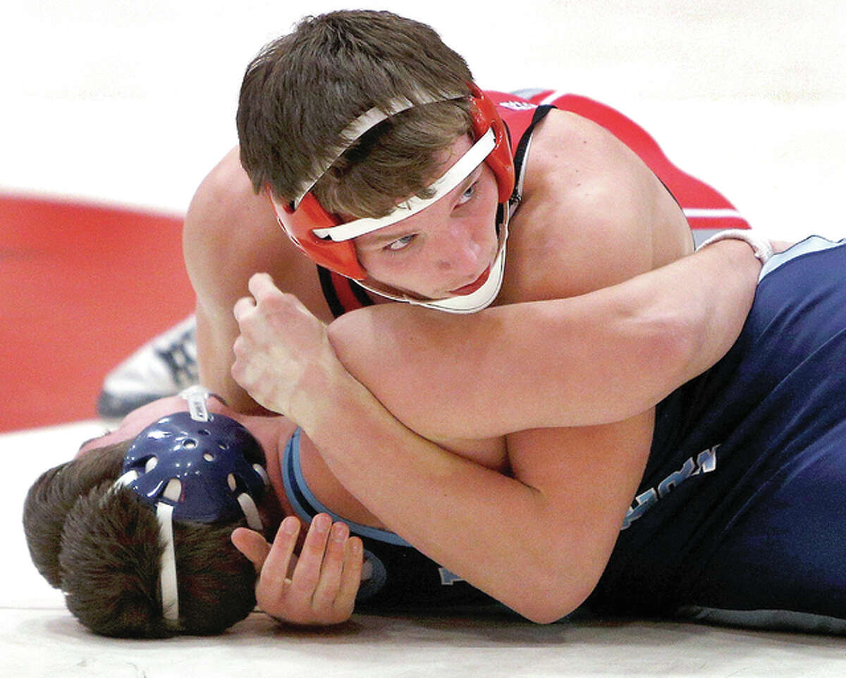 Alton’s Nolan Woszczynski, top, looks to the sideline as he grapples with Ian Austin of Belleville East in 170-pound action Wednesday night at AHS. Woszczynski pinned Austin in 3:52 in Alton’s 54-24 victory.