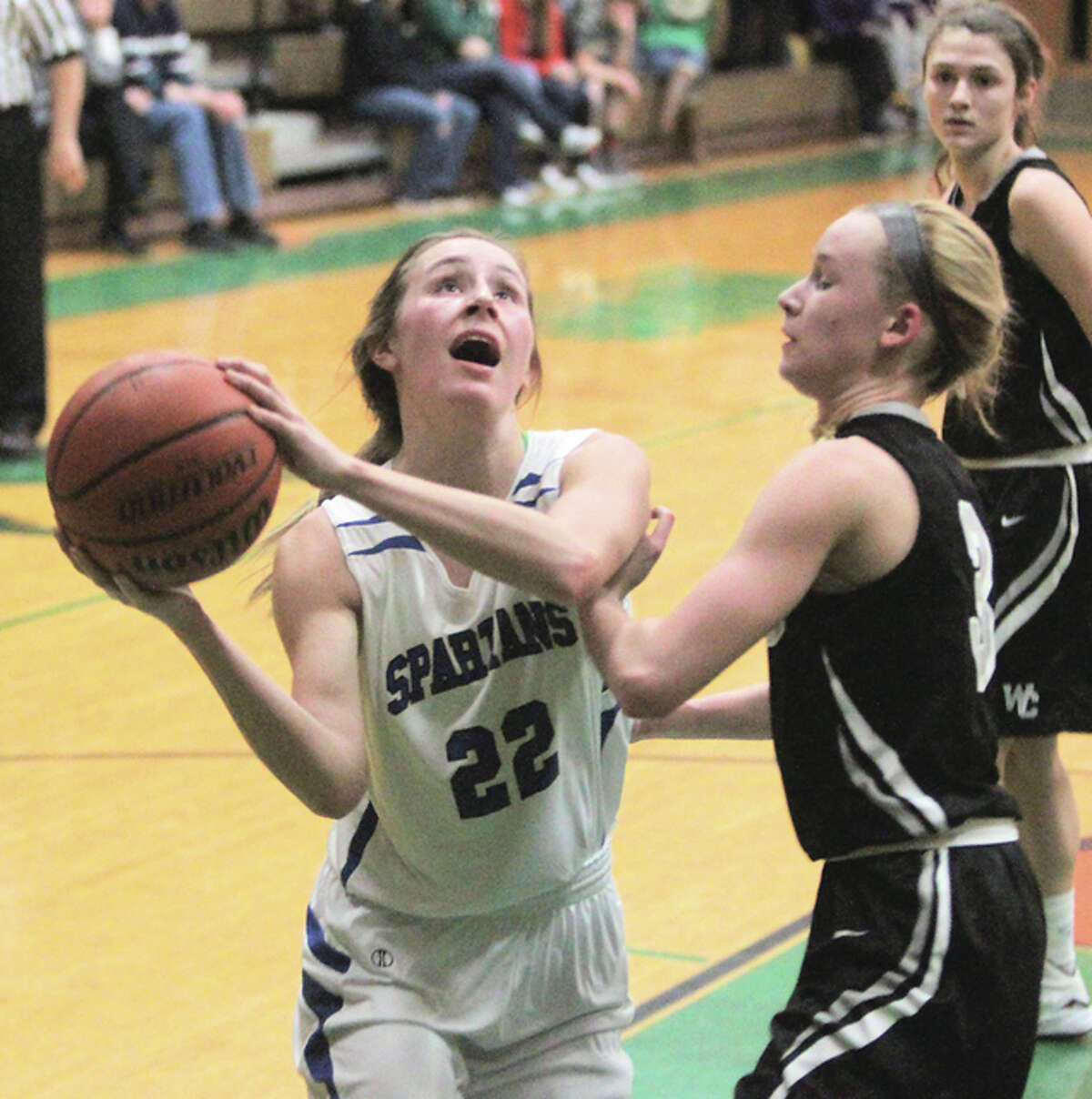 North Greene’s Sydney McClenning (22) puts up a shot over a West Central defender in Tuesday’s quarterfinals at the Carrollton Tournament. The 19-5 Spartans came back from that loss to win Friday night and get within one victory over their first 20-win season since 1999.
