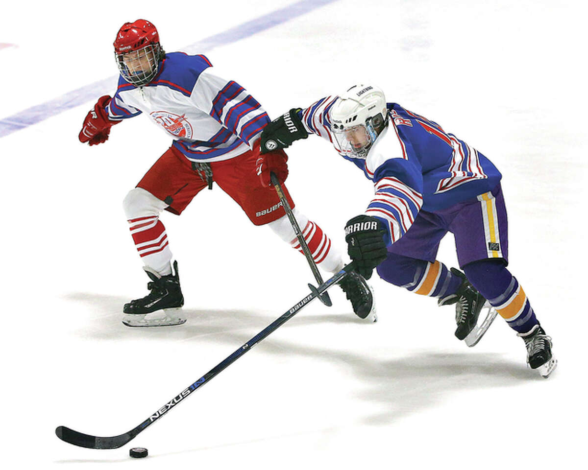 Bethalto’s Anthony Russo (right) attempts to gain possession of the puck as he is pressured by Alton’s Bryce Simon in Monday’s MVCHA Class 1A All-Star game at the East Alton Ice Arena.