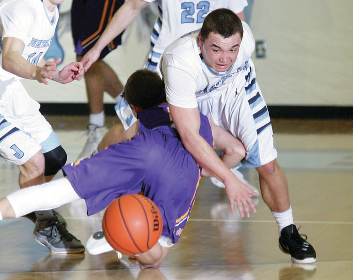 Jersey’s Jacob Witt gets tangled up with CM’s Caden Clark while going after a loose ball Friday night in Jerseyville.