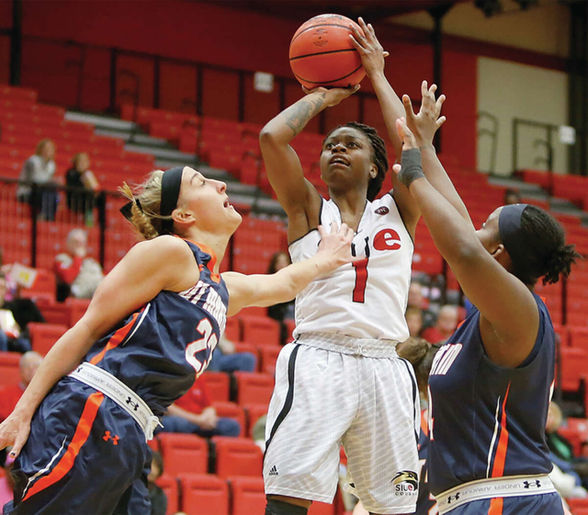 SIUE’s CoCo Moore (middle) puts up a shot contested by UT Martin’s Haley Howard (left) and Shy Copney during OVC women’s basketball action Saturday afternoon at Vadalabene Center in Edwardsville.