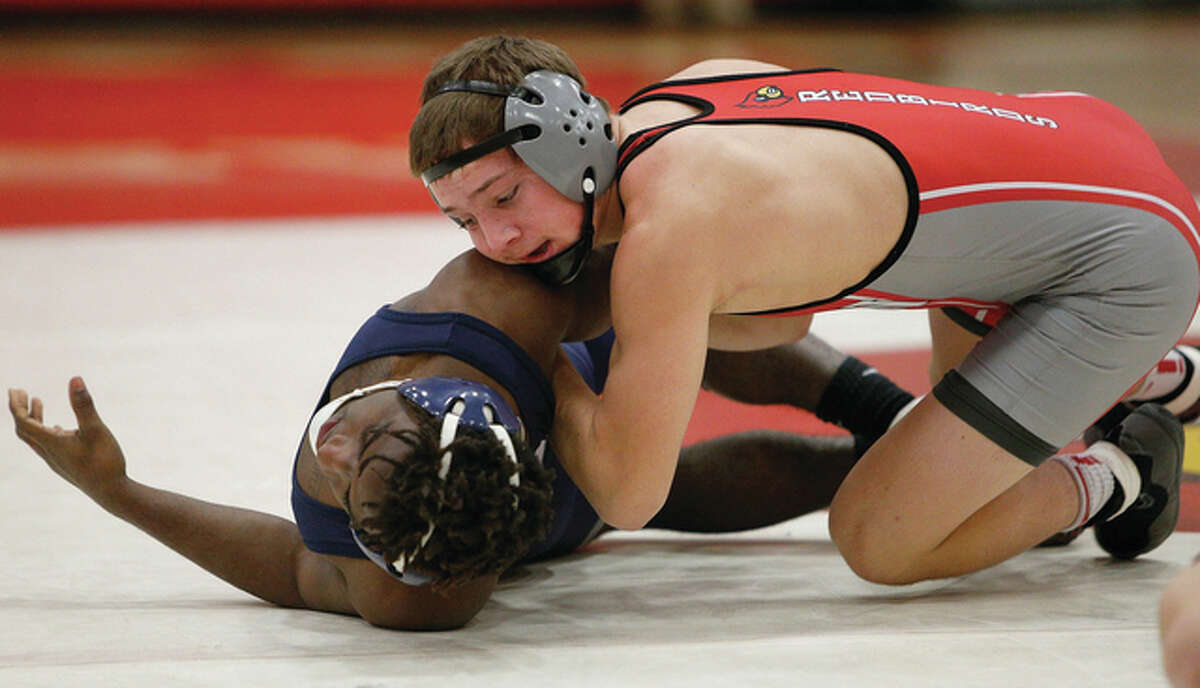Alton senior Connor Broyles (right), shown putting Belleville East’s Justin Sanders on his back during a match Jan. 27 at Alton High, moved his record to 40-3 while winning a Class 3A regional championship at 132 pounds on Saturday at Quincy.
