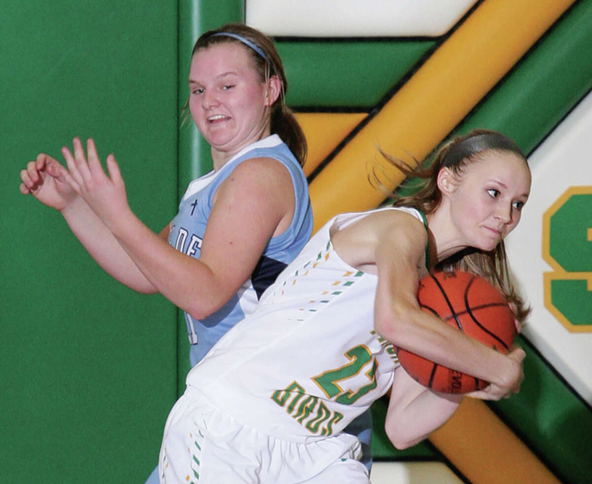 Southwestern’s Malea Bailey (right) pulls a rebound away from away from Breese Mater Dei’s Kelsey Gerdes during a Piasa Birds win Dec. 12 in Piasa. The Birds take a 43-game home-court winning streak into this week’s Southwestern Class 2A Regional.