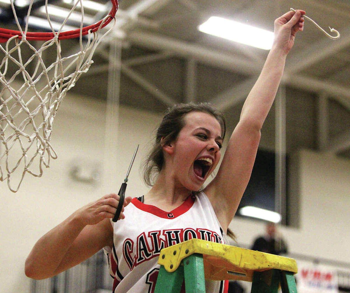 Calhoun sophomore Emily McBride celebrates her souvenir piece of net Thursday night after the Warriors beat North Greene in the championship game of the North Greene Class 1A Regional in White Hall