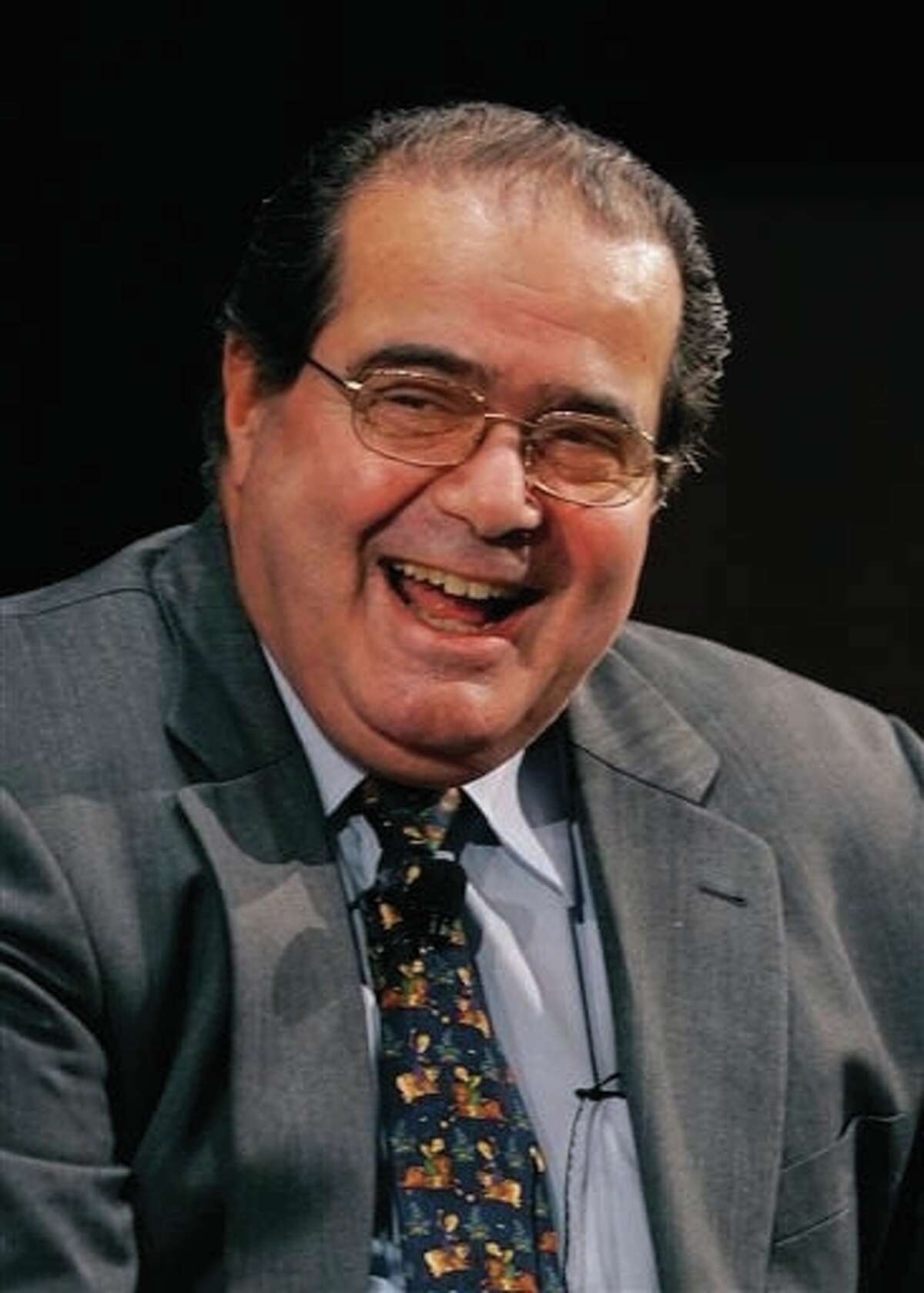 In this Wednesday, Jan. 10, 2007 file photo, Supreme Court Justice Antonin Scalia smiles during his introduction at the Intercontinental Hotel in Cleveland, as part of a Cleveland Clinic speakers series. On Saturday, Feb. 13, the U.S. Marshals Service confirmed that Scalia has died at the age of 79.