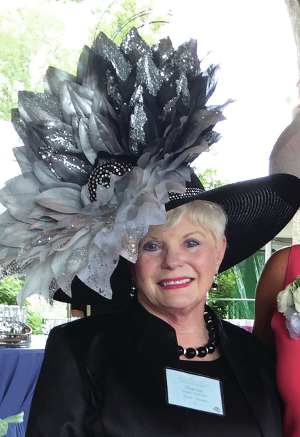 This stunner that Dianne Isbell created and is wearing was the 2015 Forest Park Forever hat winner in the Anniversary category. The Forest Park Forever Hat Luncheon is an annual fundraising event, which more than 1,100 women pay to attend each year. From 16 to 20 hat winners are selected each year from all of these women. Isbell has won six consecutive years and five of her customers have been winners (one each year for five years). 3) These are the photos sent to me for being a winner in New York’s Fall Fashion Week — my picture wearing my winning fascinator was on the Jumbo Tron in Times Square the final day of Fashion Week. 4) 5) 6) my winning “Black Lace Twirl” headband fascinator at Forest Park Forever Hat Luncheon 7) My winning “Poppy Hat” for Forest Park Forever
