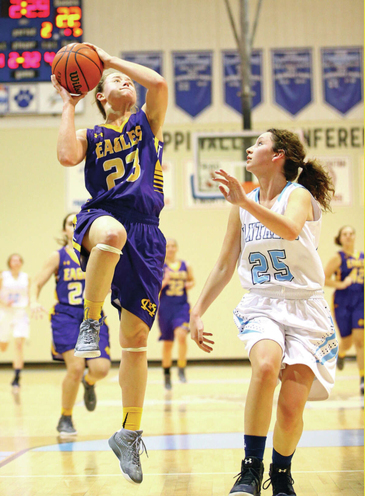 CM’s Allie Troeckler (left) puts up a shot over Jersey’s Ally Schroeder during a Dec. 28 tournament game at Jerseyville. Troeckler had 27 points and 12 rebounds in Tuesday’s semifinal win over Effingham at the Salem Class 3A Regional.
