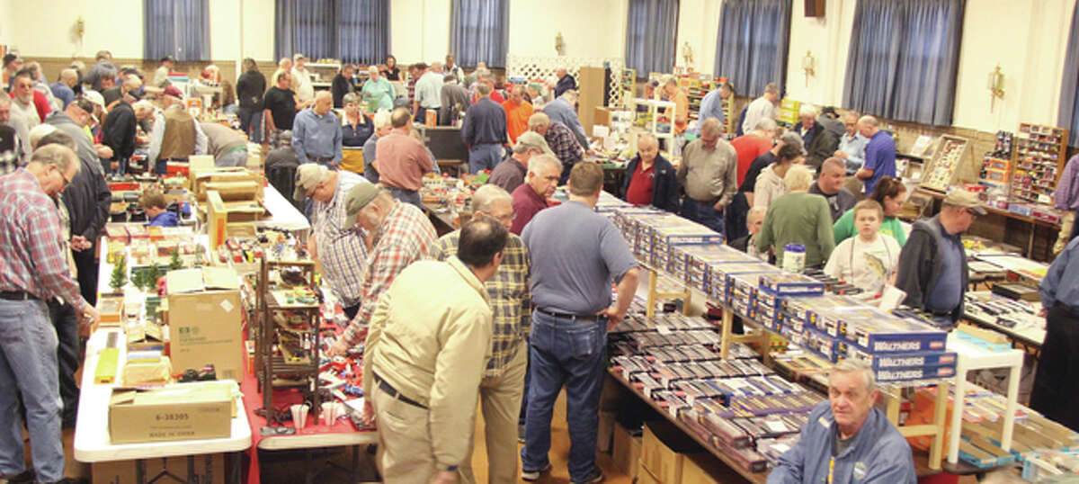 Model train enthusiasts look over trains and accessories at the annual Franklin Lodge Train Show, held Saturday in Alton. More than 50 vendors set up tables for the annual show.