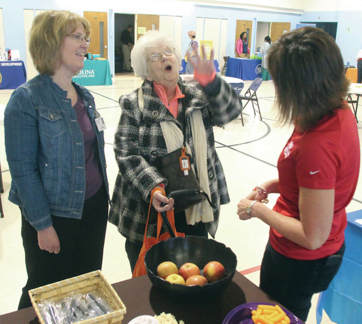 Patricia Davis, center, talks to Carol Sievers, a registered dietitian at St. Anthony’s Health Center, and the hospital’s Director of Marketing Diane Schutte during a Heart Health Fair at the Alton Salvation Army Saturday. The fair, sponsored by State Rep. Dan Beiser (D-Alton) and organized by Wellness/Harmony in conjunction with American Heart Month, featured 15 different vendors providing both information and free screenings.