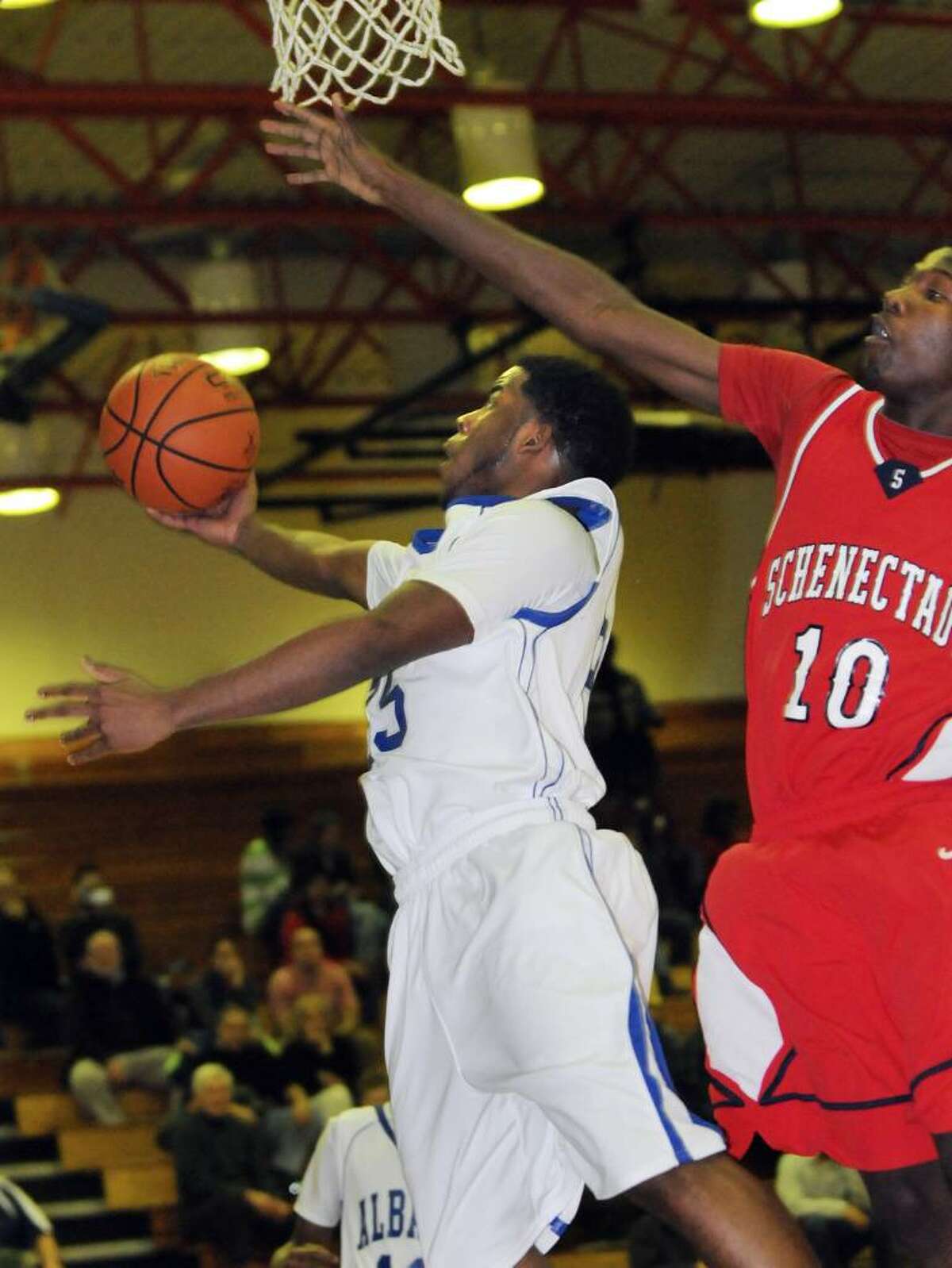 Albany's Jaylon Glasgow, left, goes up for a basket as Schenectady's Jallah Tarver defends during their basketball game on Friday at Albany High. Albany won 72-65. (Cindy Schultz / Times Union)