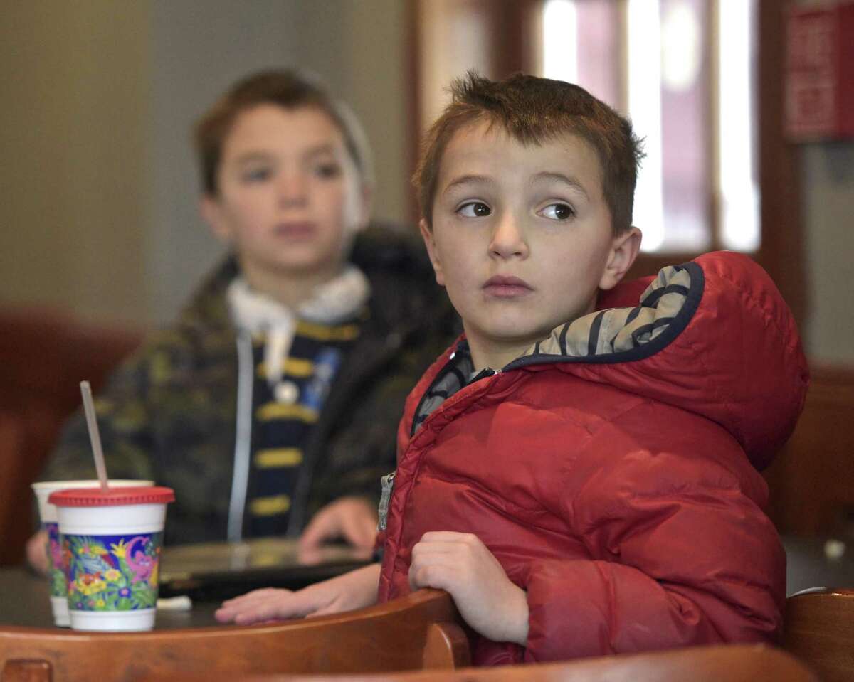 Twins Harris, right, and Carson Dressel, 6, of Ridgefield, watch Ridgefield Olympian Tucker West compete in the men’s luge at the 2018 PyeongChang Olympic Games, South Korea, at the Tigers Den Sports Bar and Grill in Ridgefield on Saturday.