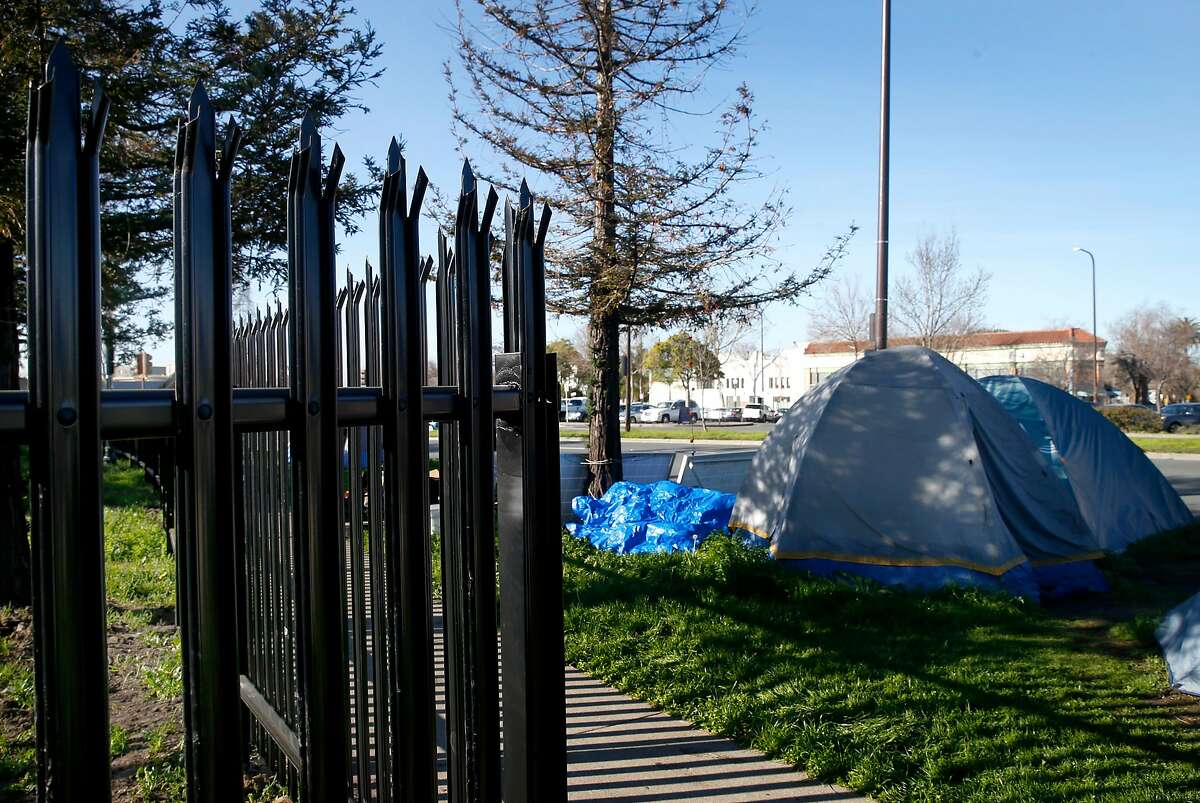 A spiked steel fence is erected at the site of a former homeless encampment next to BART tracks at Martin Luther King Jr. Boulevard and 63rd Street in Berkeley, Calif. on Saturday, Feb. 10, 2018. BART installed the fence to prevent the campers from returning but the prison-like fence has angered a Berkeley city council member and many residents.