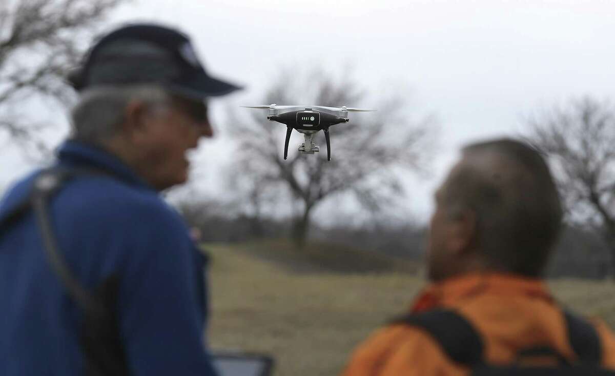 Drone pilot Robert Youens of Austin (left) chats with Stef Hendrik about flying a drone as hobbyists and the public attend the 2018 San Antonio Winterfest Drone Fly-in at the former Alamo Golf Course on Saturday, Feb. 10, 2018. The event featured flying demonstrations, workshops and exhibits on the Northwest Side. The event was held in what is called Class G airspace, which has no restrictions on drone flight other than basic rules. (Kin Man Hui/San Antonio Express-News)