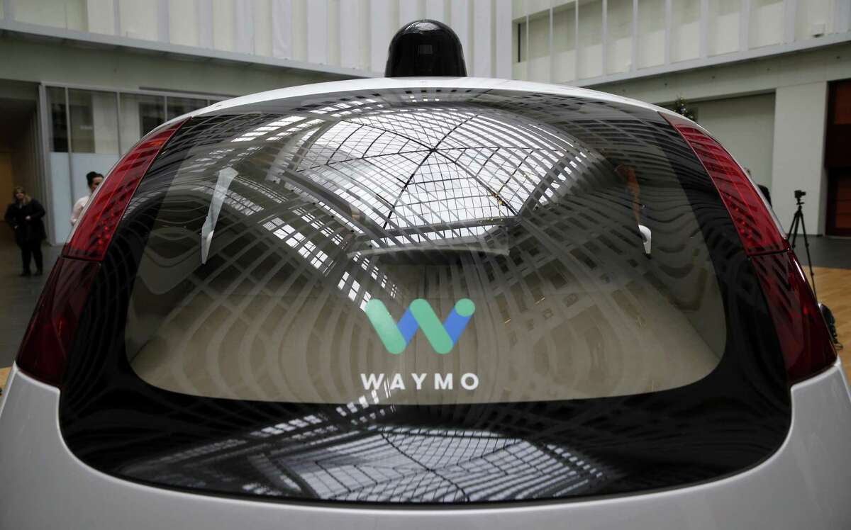 The Waymo self-driving car, seen from the rear, is unveiled at Google’s offices in 2016.