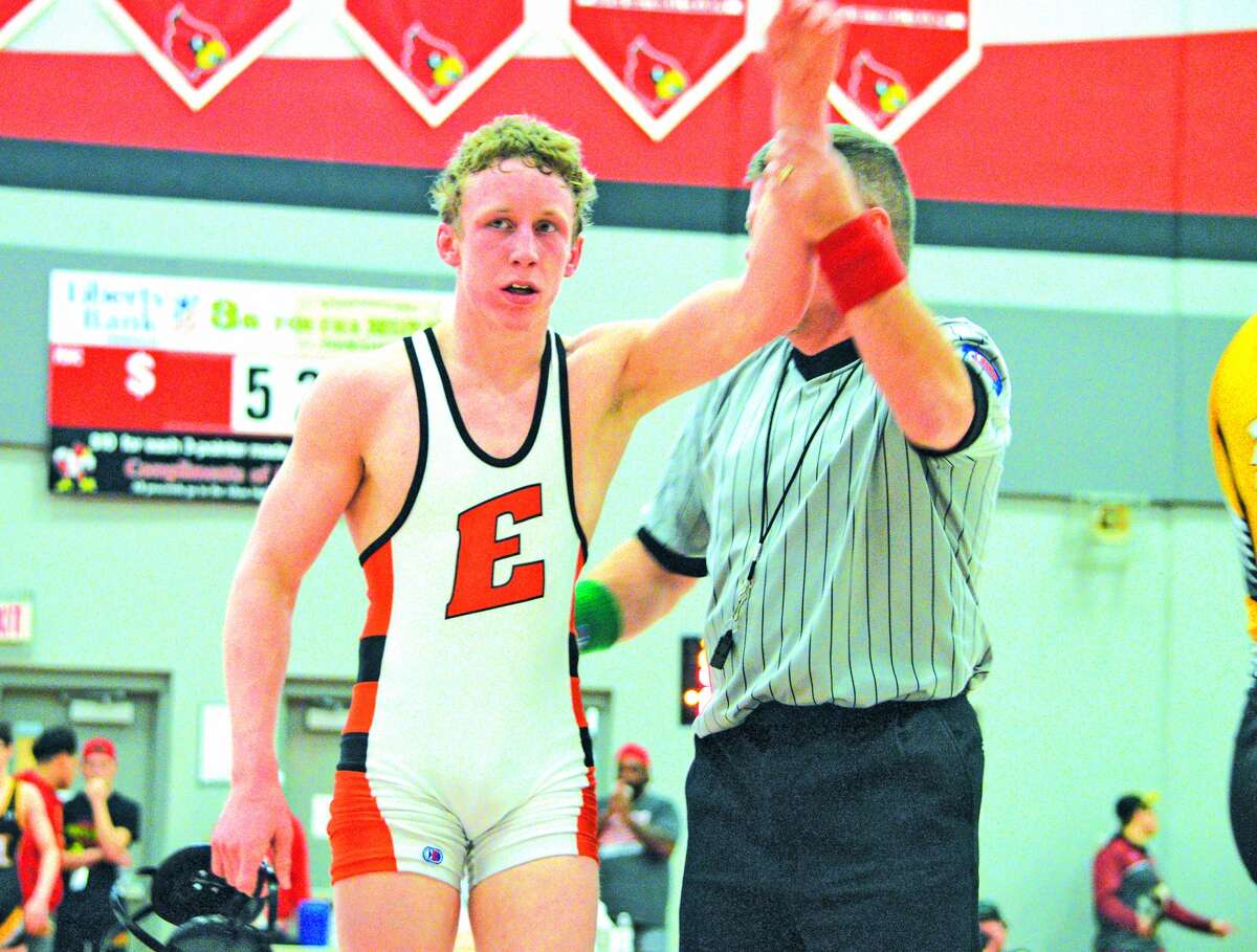 Edwardsville sophomore Luke Odom left, has his hand raised by the referee to signify his victory over Carlos Champagne of Chicago Heights Marian on Saturday in the championship match of the Class 3A Alton Sectional.