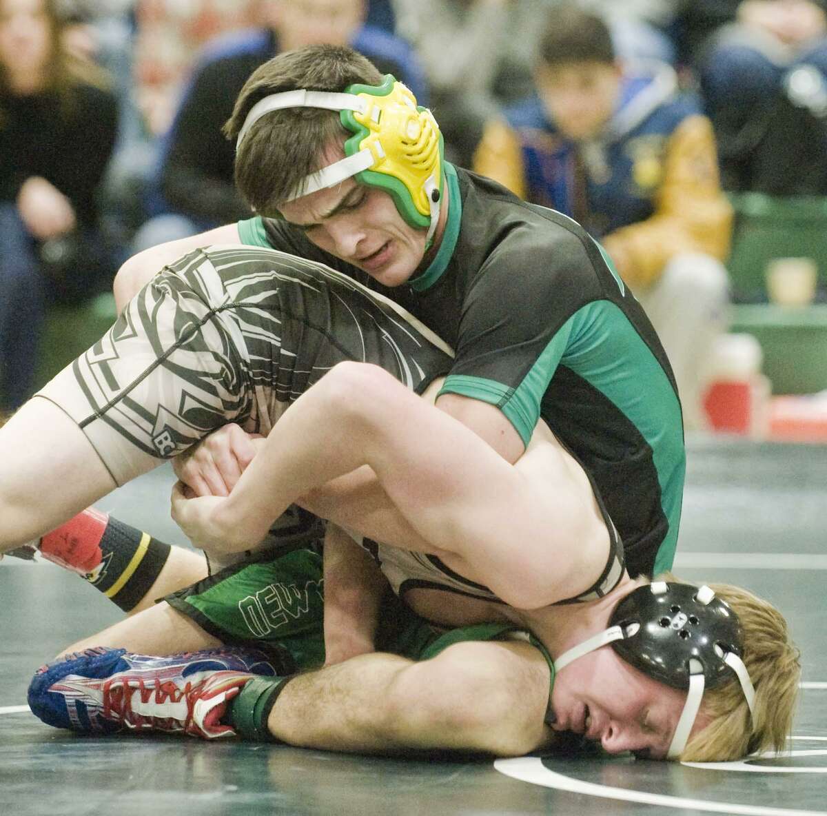 New Milford High School's Luke Schell squeezes Joel Barlow High School's Charlie Prather in the 113 lb. finals of the SWC wrestling Championships at New Milford High School. Saturday, Feb. 10, 2018