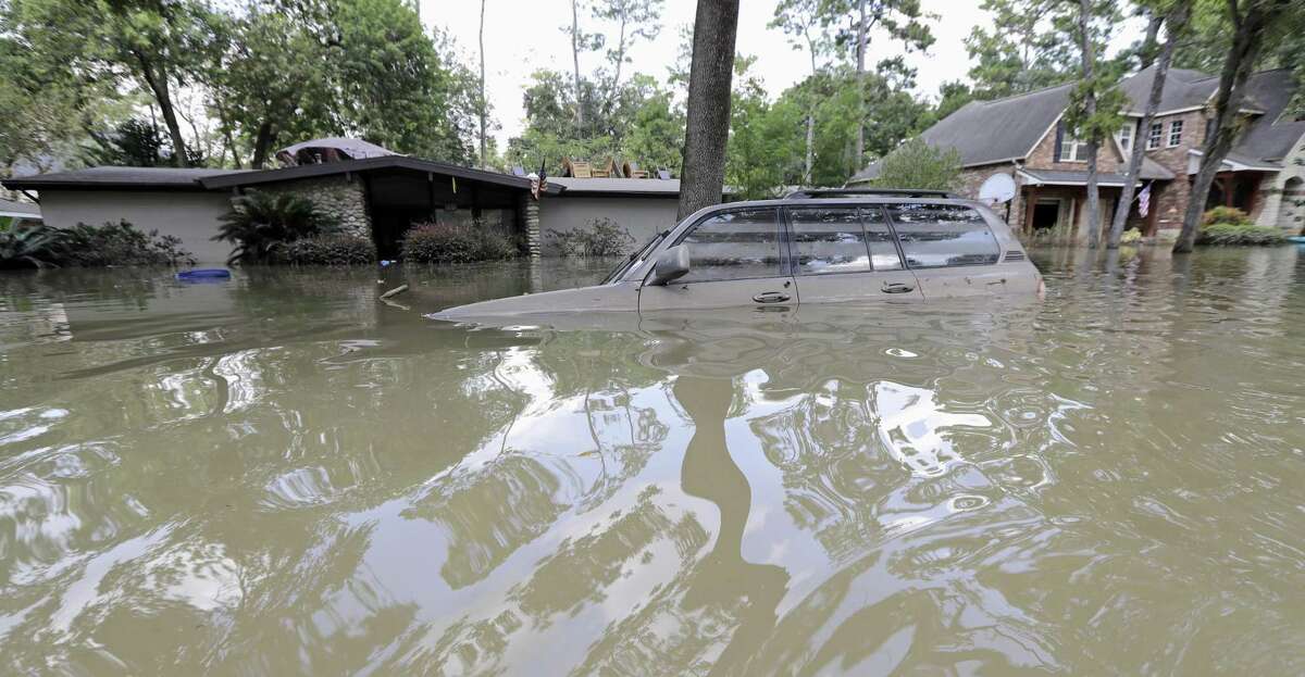 In this Sept. 4 photo, a car is submerged in floodwaters in the aftermath of Hurricane Harvey near the Addicks and Barker Reservoirs in Houston. The budget bill includes an $89.3 billion disaster aid package for Texas, Florida, Puerto Rico and other areas hit by a series of floods, fires and hurricanes last year.