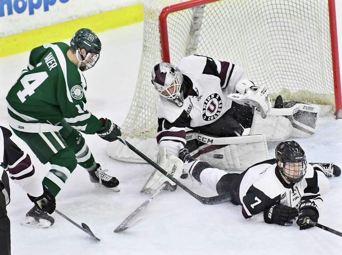 Union's goaltender Jake Kupsky (1) reaches over teammate Brandon Estes (7) to block a shot by Dartmouth's forward Matt Baker (14) during the first period of an NCAA college hockey game Saturday, Feb. 10, 2018, in Schenectady, N.Y., (Hans Pennink / Special to the Times Union)