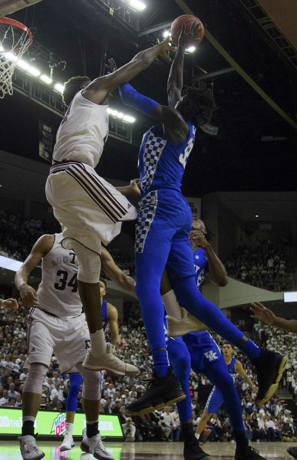 A&M forward Robert Williams (left) contests a shot by Kentucky forward Wenyen Gabriel during the second half.